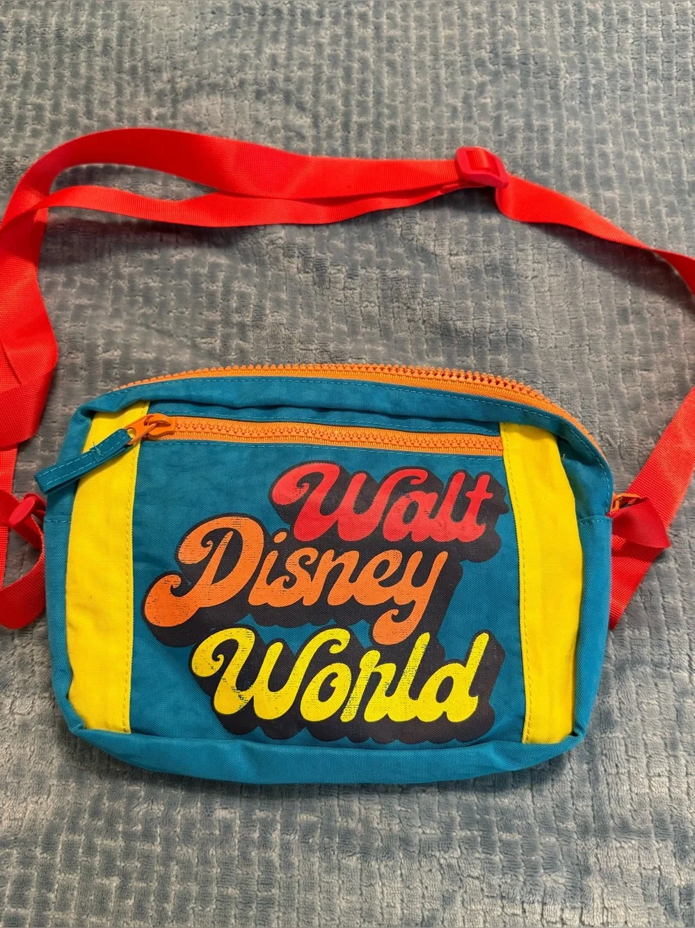 Walt Disney World Kids Teal Crossbody Bag with Yellow Panels and Red Strap